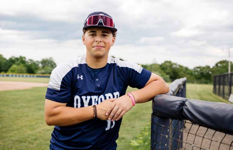 Cole Cianflone leaning on dugout fence